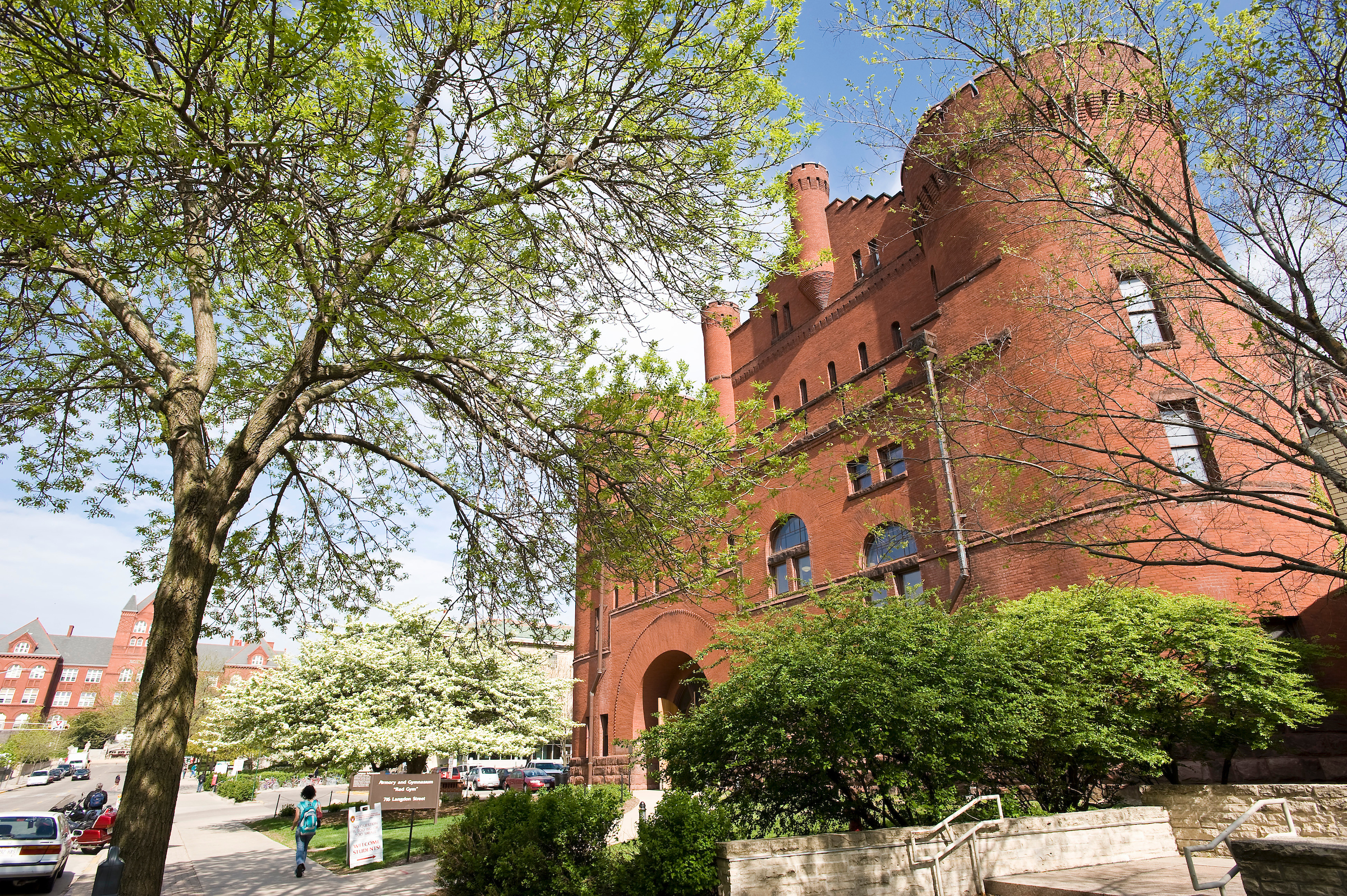 Budding trees frame the Armory and Gymnasium (Red Gym) at the University of Wisconsin-Madison during spring