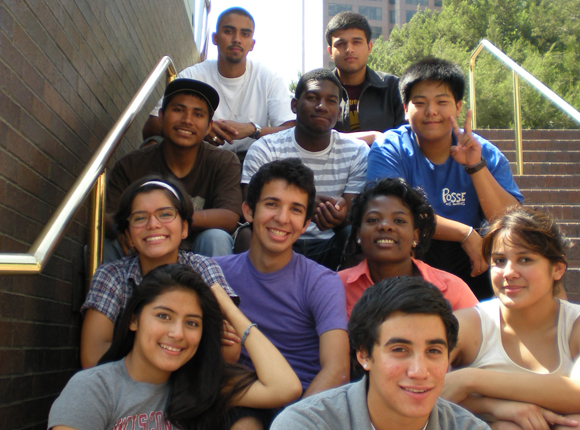 A group of LA Posse scholars pose seated on an outdoor staircase.