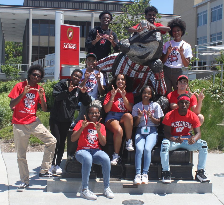 A group of Posse scholars pose around a statue of Bucky Badger at Alumni Park