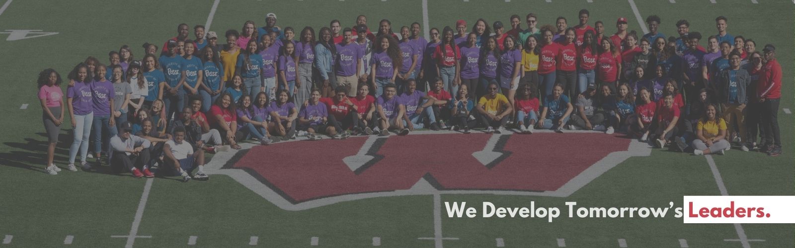 Posse scholars pose on the 50 yard line at Camp Randall Stadium